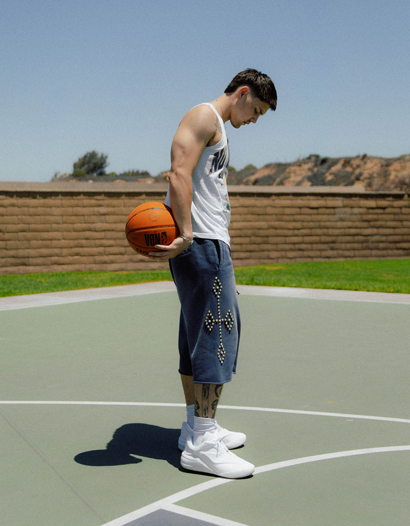Commons Studios pearled star sweatshort in navy, worn on a basketball court